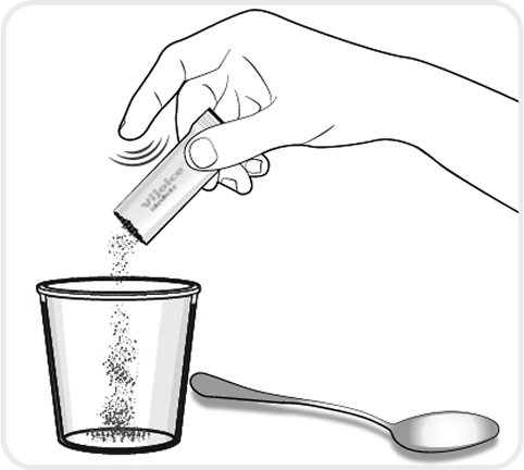 figure D_oral granules – a hand pouring granules from the packet into a cup with a spoon lying next to the cup