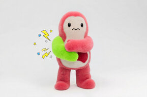 Kiki holding her green enlarged arm to represent pain.